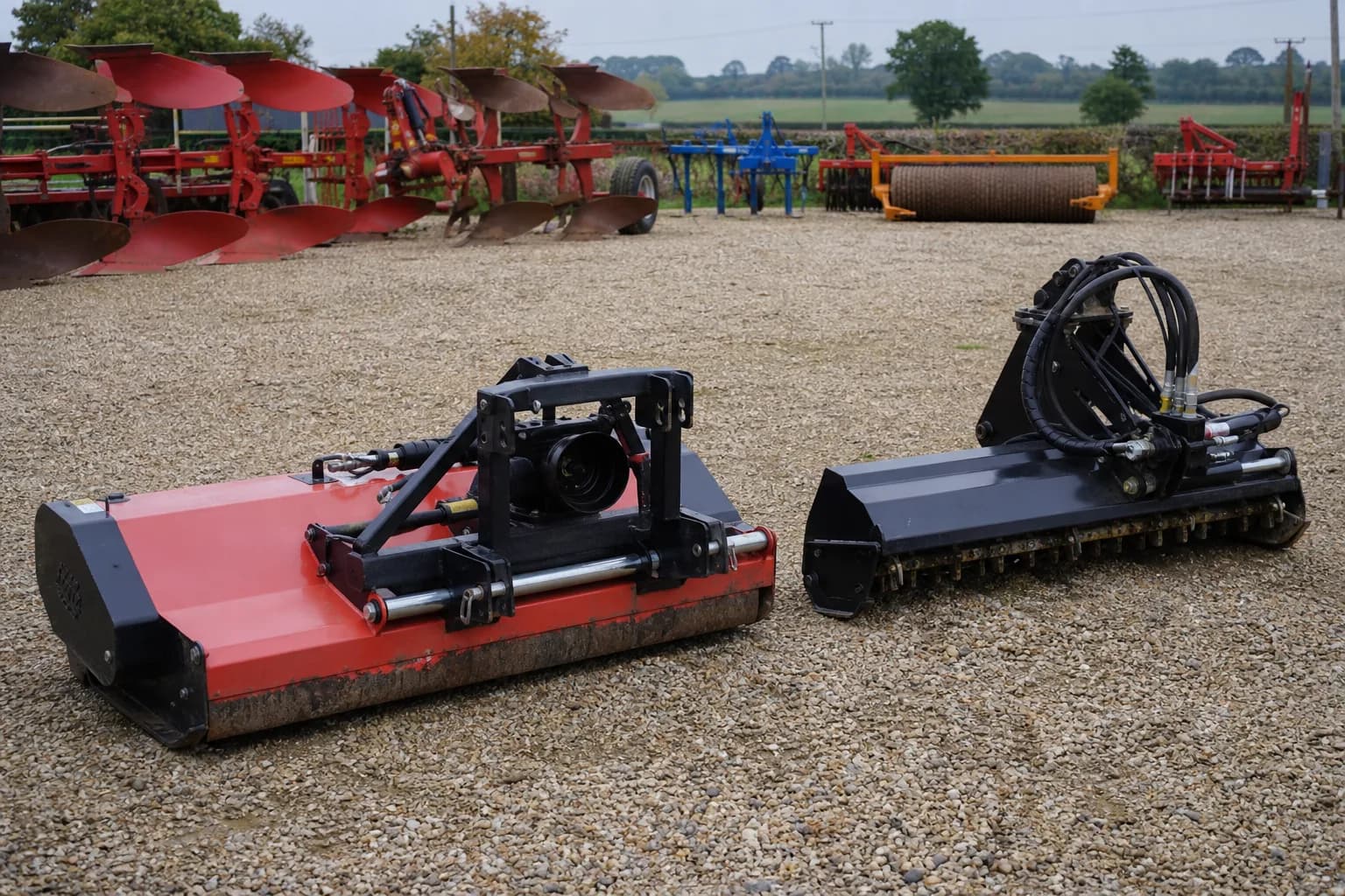 Agricultural equipment and attachments arranged in a rural farm yard